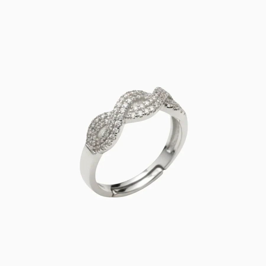 Silver ring with diamond accents on a white background